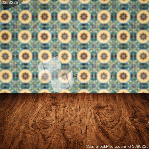 Image of Wood table top and blur vintage ceramic tile pattern wall