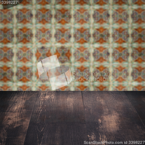 Image of Wood table top and blur vintage ceramic tile pattern wall