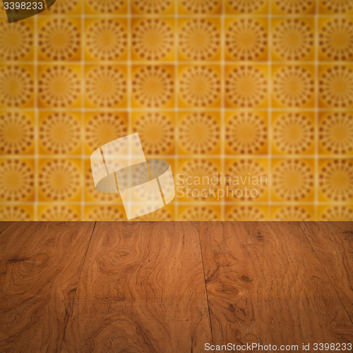 Image of Wood table top and blur vintage ceramic tile pattern wall