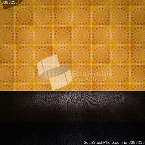 Image of Wood table top and blur vintage ceramic tile pattern wall