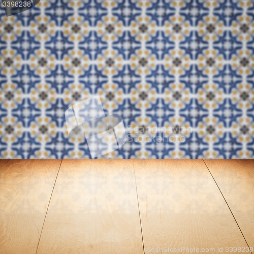 Image of Wood table top and blur vintage ceramic tile pattern wall