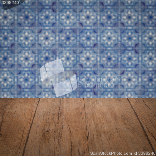 Image of Wood table top and blur vintage ceramic tile pattern wall