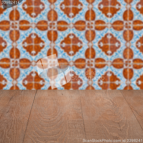 Image of Wood table top and blur vintage ceramic tile pattern wall