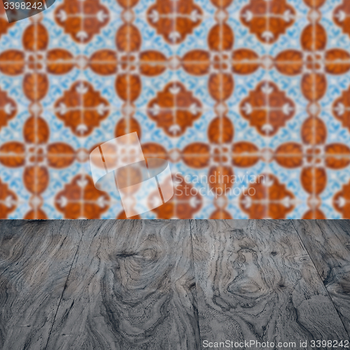 Image of Wood table top and blur vintage ceramic tile pattern wall