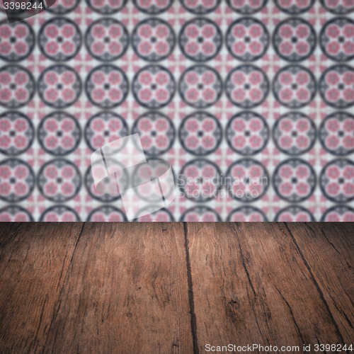 Image of Wood table top and blur vintage ceramic tile pattern wall