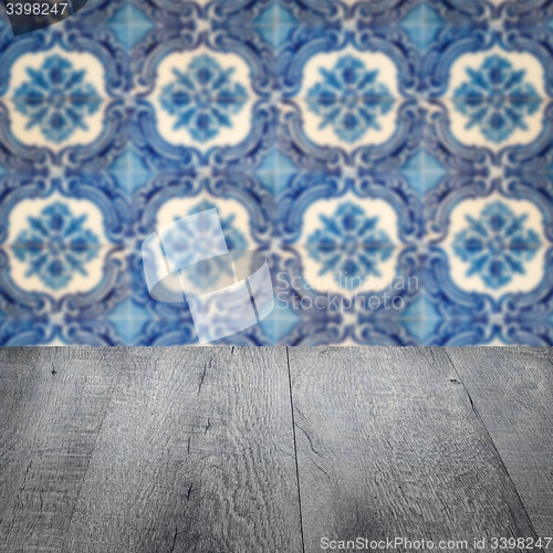 Image of Wood table top and blur vintage ceramic tile pattern wall