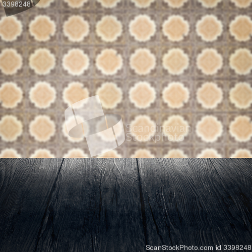 Image of Wood table top and blur vintage ceramic tile pattern wall