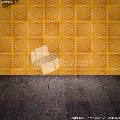 Image of Wood table top and blur vintage ceramic tile pattern wall