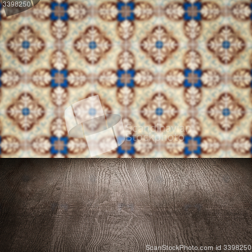 Image of Wood table top and blur vintage ceramic tile pattern wall