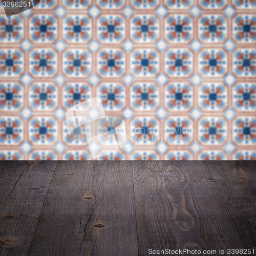 Image of Wood table top and blur vintage ceramic tile pattern wall