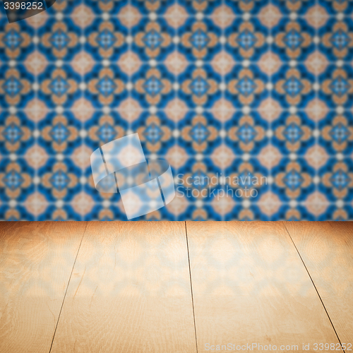 Image of Wood table top and blur vintage ceramic tile pattern wall