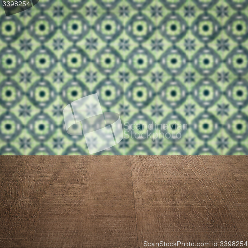 Image of Wood table top and blur vintage ceramic tile pattern wall