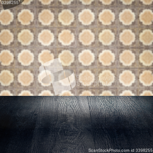 Image of Wood table top and blur vintage ceramic tile pattern wall