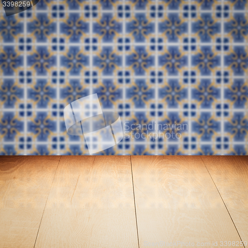 Image of Wood table top and blur vintage ceramic tile pattern wall