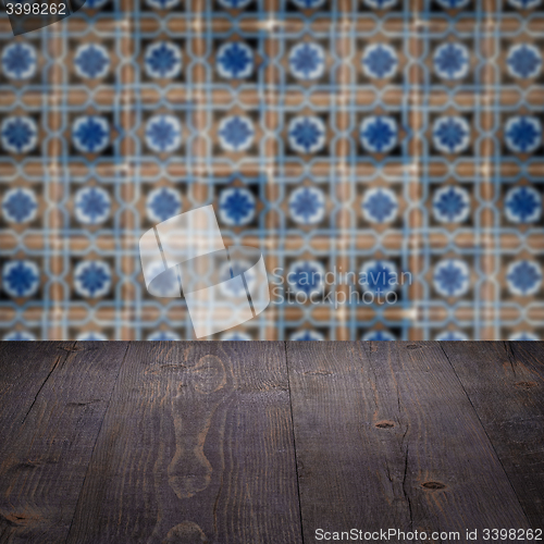 Image of Wood table top and blur vintage ceramic tile pattern wall