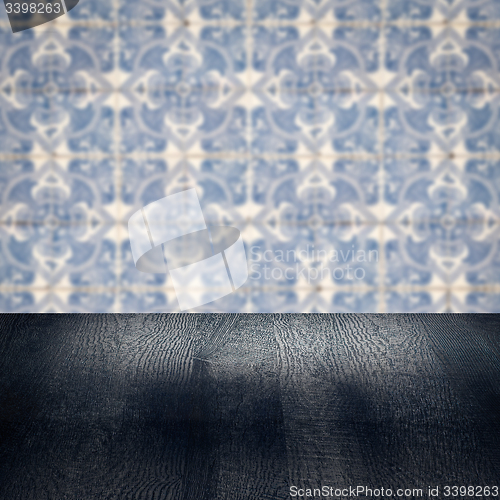 Image of Wood table top and blur vintage ceramic tile pattern wall