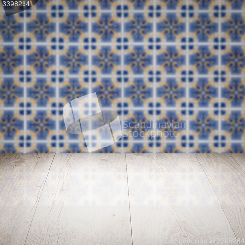 Image of Wood table top and blur vintage ceramic tile pattern wall