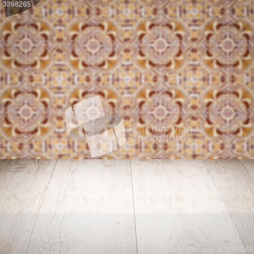 Image of Wood table top and blur vintage ceramic tile pattern wall