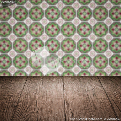 Image of Wood table top and blur vintage ceramic tile pattern wall