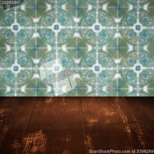 Image of Wood table top and blur vintage ceramic tile pattern wall