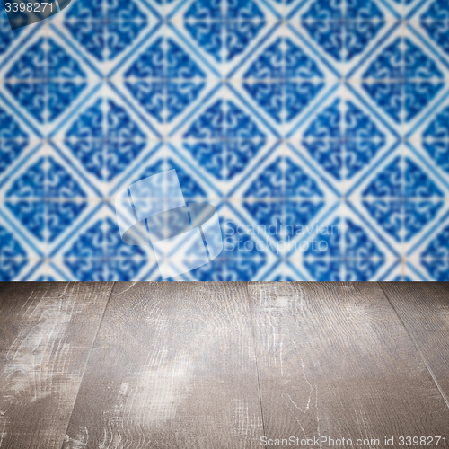 Image of Wood table top and blur vintage ceramic tile pattern wall