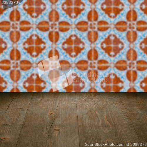 Image of Wood table top and blur vintage ceramic tile pattern wall
