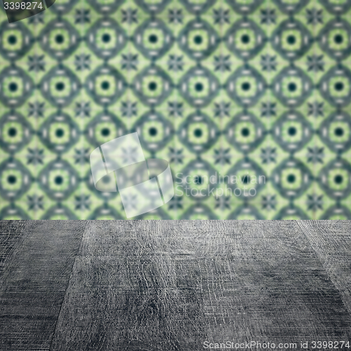 Image of Wood table top and blur vintage ceramic tile pattern wall