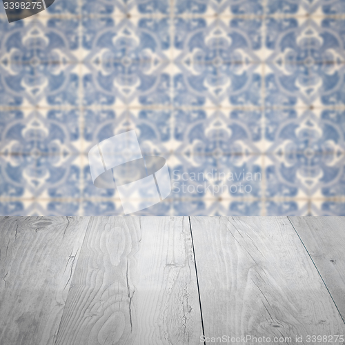 Image of Wood table top and blur vintage ceramic tile pattern wall