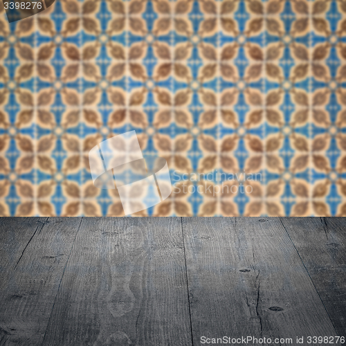 Image of Wood table top and blur vintage ceramic tile pattern wall