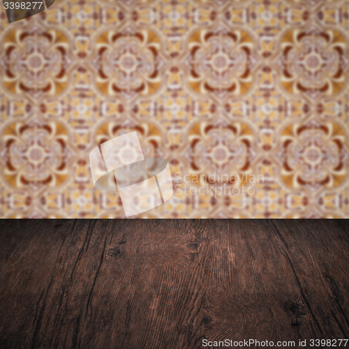 Image of Wood table top and blur vintage ceramic tile pattern wall