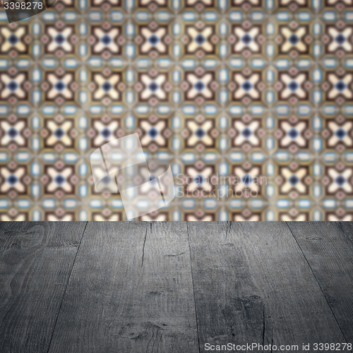 Image of Wood table top and blur vintage ceramic tile pattern wall