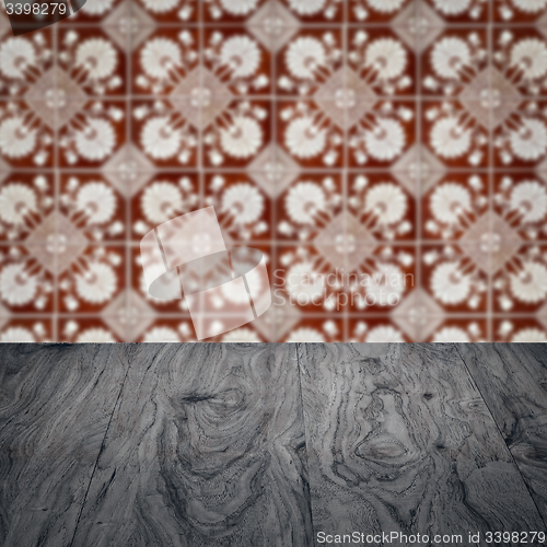 Image of Wood table top and blur vintage ceramic tile pattern wall