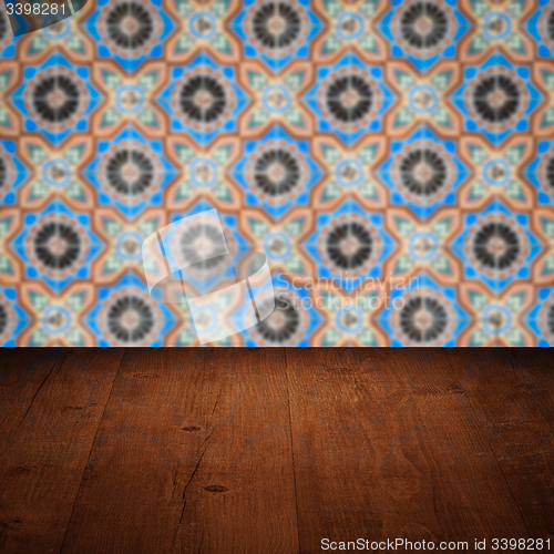 Image of Wood table top and blur vintage ceramic tile pattern wall