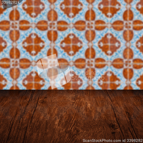 Image of Wood table top and blur vintage ceramic tile pattern wall