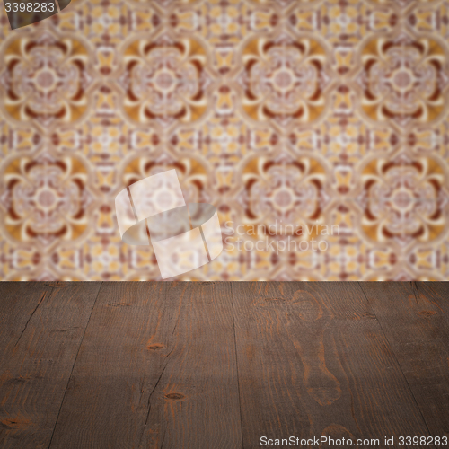 Image of Wood table top and blur vintage ceramic tile pattern wall