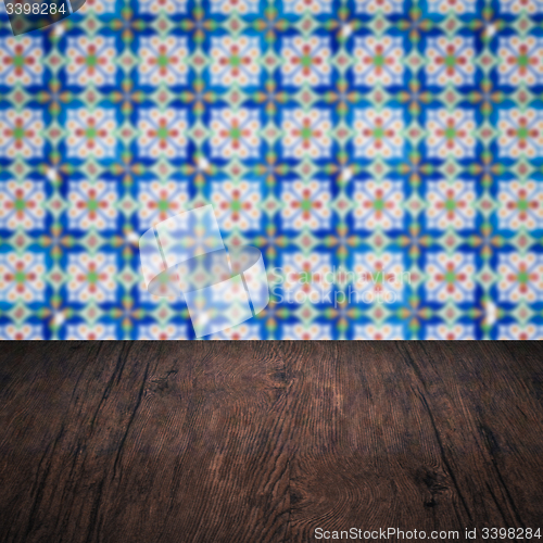 Image of Wood table top and blur vintage ceramic tile pattern wall
