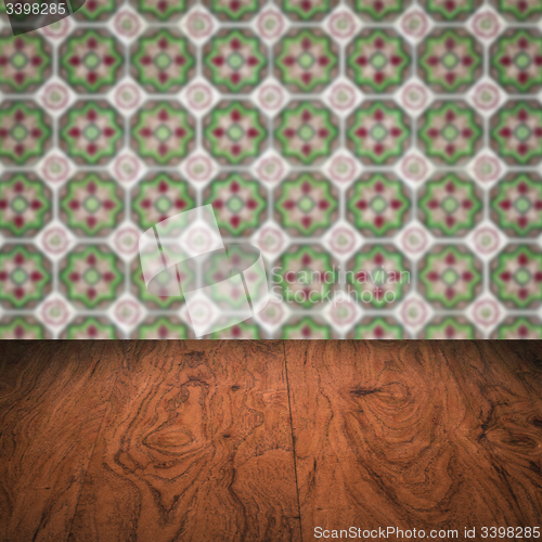 Image of Wood table top and blur vintage ceramic tile pattern wall