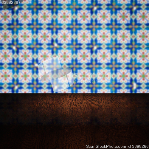 Image of Wood table top and blur vintage ceramic tile pattern wall