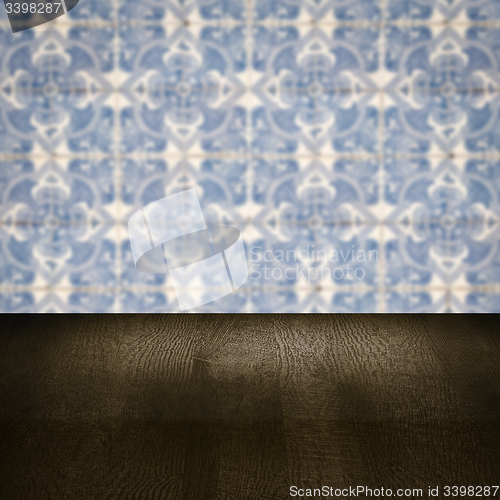 Image of Wood table top and blur vintage ceramic tile pattern wall