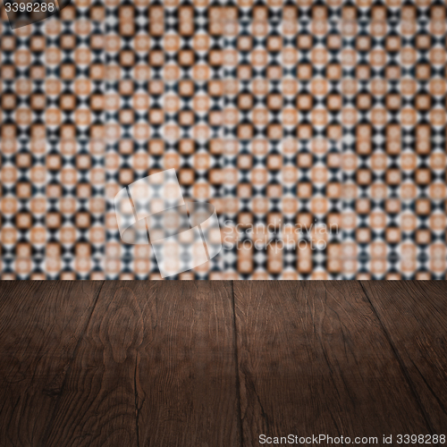 Image of Wood table top and blur vintage ceramic tile pattern wall