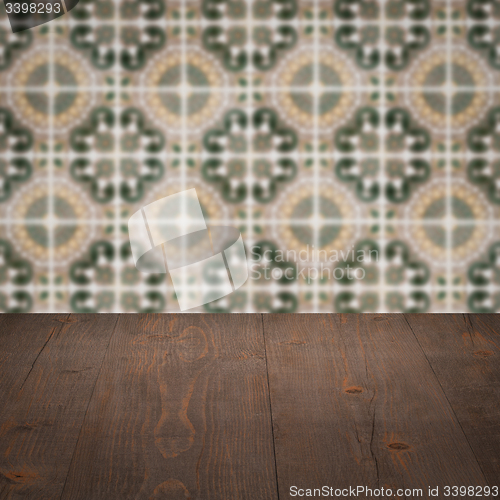 Image of Wood table top and blur vintage ceramic tile pattern wall