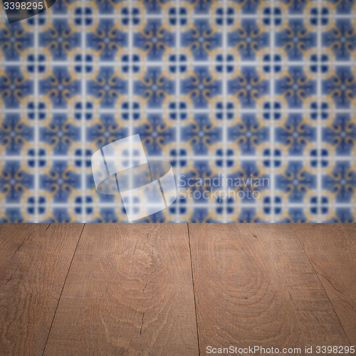 Image of Wood table top and blur vintage ceramic tile pattern wall