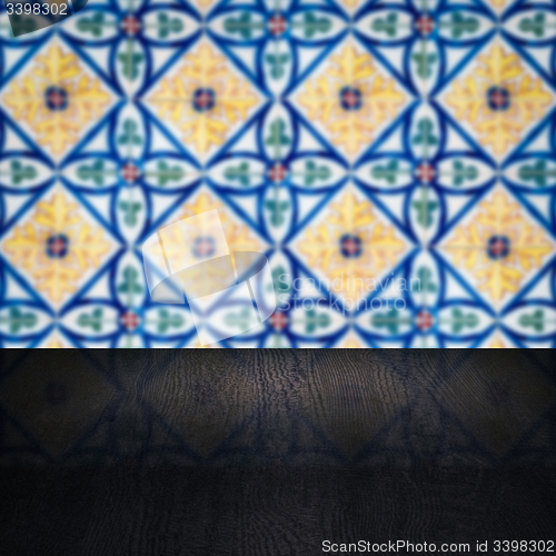 Image of Wood table top and blur vintage ceramic tile pattern wall