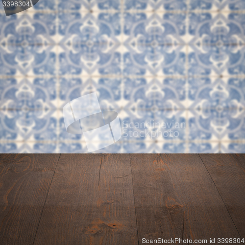 Image of Wood table top and blur vintage ceramic tile pattern wall