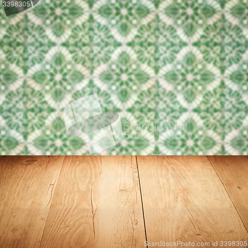 Image of Wood table top and blur vintage ceramic tile pattern wall