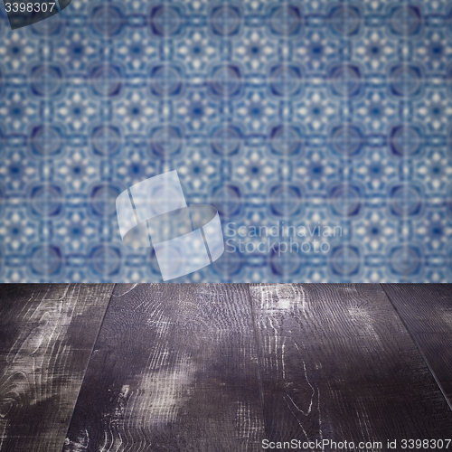 Image of Wood table top and blur vintage ceramic tile pattern wall