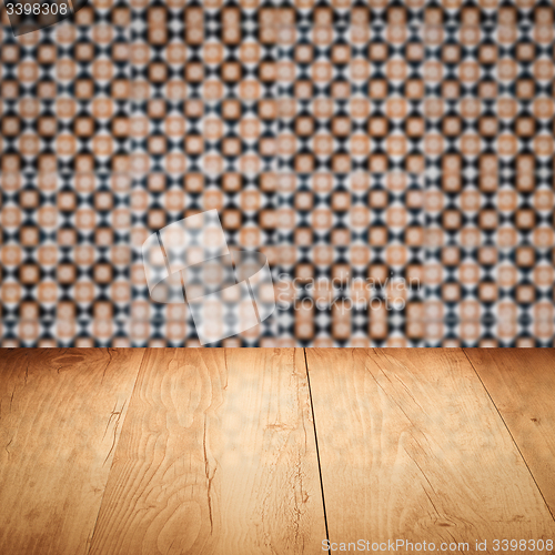 Image of Wood table top and blur vintage ceramic tile pattern wall