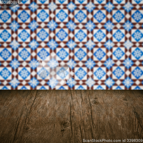 Image of Wood table top and blur vintage ceramic tile pattern wall