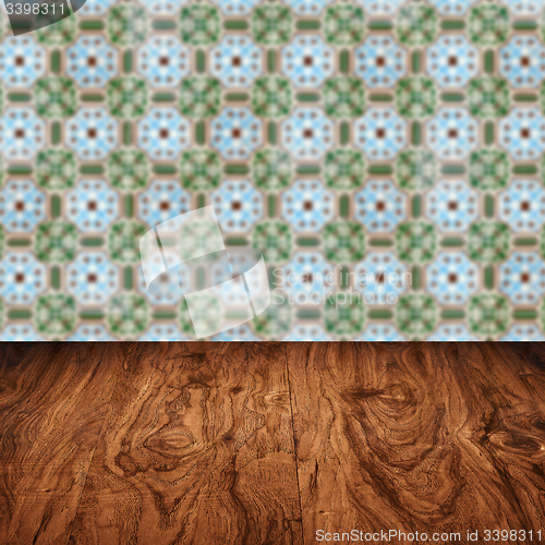 Image of Wood table top and blur vintage ceramic tile pattern wall