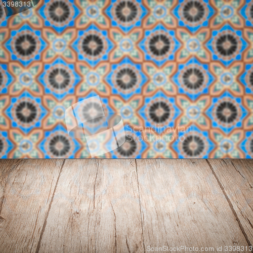 Image of Wood table top and blur vintage ceramic tile pattern wall